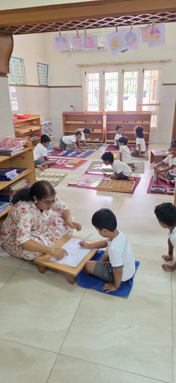 Teacher guiding student work